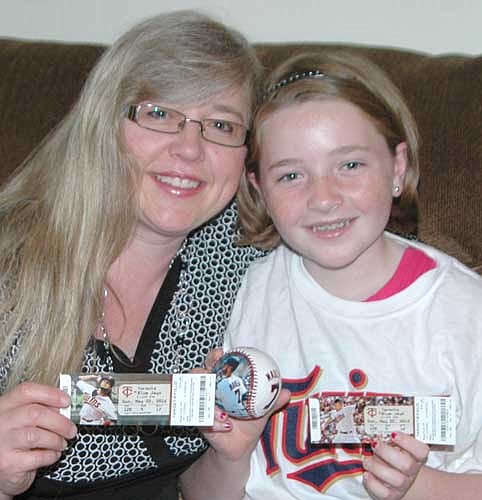 Anissa Mestad, left, and her daughter Emma display their tickets and a Joe Mauer baseball from the May 22 Minnesota Twins-Toronto Blue Jays game when Emma met and spoke with Mauer at Target Field.