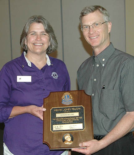 Pastor Byron Meline received the Melvin Jones Fellowship Award at the Stewartville Lions Club's installation and awards program on June 6. Diane Tlougan, Zone 3 Lions chairperson, presented the award.