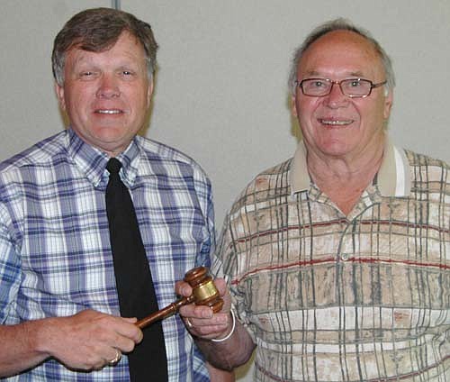 Dr. David Thompson, incoming Stewartville Lions Club president for 2016-17, accepts the gavel from Dick Uptagrafft, outgoing president.
