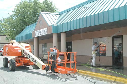 Workers prepared Stewartville's City Center Plaza for a new coat of paint last week.