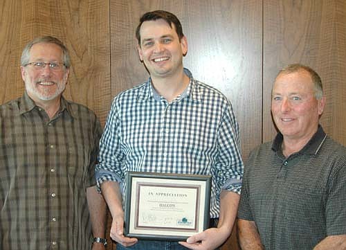 Ben Conway, president of Halcon of Stewartville, center, accepts the EDA's Business Appreciation Award from Chris Stafford, EDA president, left; and Mayor Jimmie-John King, an EDA member, during the EDA's meeting at Halcon last week.