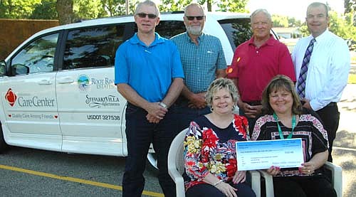The Stewartville Area Community Foundation has donated $500 to the Stewartville Care Center toward the purchase of the van pictured in the background. Cheryl Roeder, executive director of the Foundation, seated at left, shares a $500 check with Sherri Jorgensen, activities director at the Care Center. Foundation trustees standing in back include, from left, Jeff Beyer, Les Radcliffe, Jerry Burgr and Ben Van Ness.
