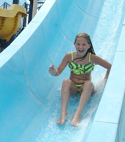 Kylie Minnich, 9, of Stewartville, who will be a fourth grader at Bear Cave Intermediate School this fall, has almost completed her descent on the blue slide at the Stewartville pool on Tuesday afternoon, June 28.