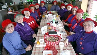 THE RED HAT LADIES -- Twelve members of "The Sisterhood of the Scarlet O'Hatters," led by Bess David, the group's queen mother, met for lunch at Corner Meats -N-More last Thursday, Feb. 21. After lunch, the ladies gathered at Jan's Costume Creations, the Stewartville business owned by Jan Lubahn, one of the group's members.  Members of the group include, from left, Rosemary Oeltjen, Pat Ballinger, Jan Lubahn, Kay Boyum, Connie Hayes, Sharon Otteson, Carolyn Barsness, Marlice Boland, Suzanne Idso, Joan Titus, Bess David and Roxanna Johnson.  Club members absent from the gathering include Ardis Copple, Patricia Distad, Marilyn Honsey, Jean Nelson and Jean Schwarz. 