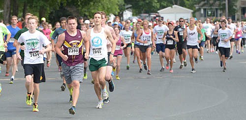 A  sea of runners stretches backward as far as the eye can see at the start of the Summerfest three-mile run. In all, 306 runners and walkers took part in the three-mile and another 154 ran the five-mile event.