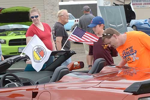 Browsers inspect a classic car during the annual Fourth of July Stewie Cruisers Car Show near the Stewartville American Legion Post 164.
