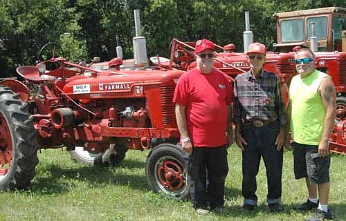 Walter M. "Sonny"&#8200;Podein, 86, center, and his sons Craig, left, and Jeff brought 26 International Harvester tractors and about 15 Cub Cadets to the Root River Antique Historical Power Association's annual Antique Engine and Tractor Show last week. Sonny's favorite is the 1945 Farmall H, pictured above, which was brand new when the 15-year-old Sonny drove it home from Rochester in 1945.