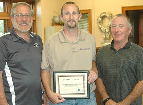 Micah Johansen, service manager for Schwickert's of Stewartville, center, accepts the EDA's Business Appreciation Award from Chris Stafford, EDA president, left, and Mayor Jimmie-John King, a member of the EDA.