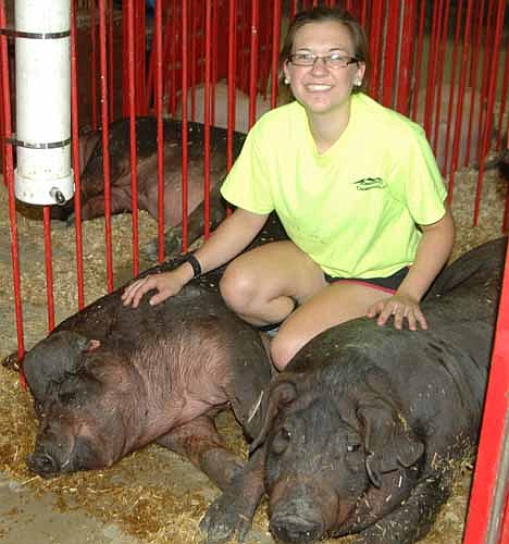 Amelia Welter showed three pigs at this year's Olmsted County Fair. She says that whenever she shows pigs, she follows an established routine. "The biggest thing is to try to take them on walks around our farm," she said.