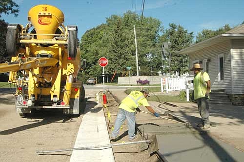 Workers smoothed the surface for the new sidewalks along Fourth Street Northeast last week.