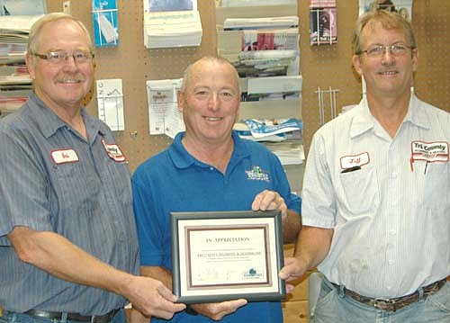 Mayor Jimmie-John King, a member of the city's EDA, center, presents Bob Klocke, left, and Jeff Anderson of Tri County Plumbing & Heating with the EDA's Business Appreciation Award on Friday morning, Aug. 19.