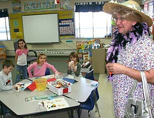 A PRINCIPAL'S PUNISHMENT -- After Bonner Elementary School students surpassed a goal of reading for 200,000 minutes during February "I Love to Read" month, Dave Nystuen, the school's principal, visited all the school's classrooms in less-than-typical clothing last week. Nystuen had promised to wear a feather boa if the students read for more than 50,000 minutes, a wig if they surpassed 100,000 minutes, jewelry if they exceeded 150,000 minutes and a dress if they surpassed 200,000 minutes.  In all, the students read for 207,580 minutes in February. 