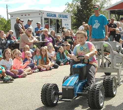 Kid Power Pedal Tractor Pulls of Hanlontown, Iowa came to the High Forest Old Settlers Day celebration on Saturday, Sept. 10. Above, Alexander Schrader, 5, of Rochester, enjoys his opportunity to compete.
