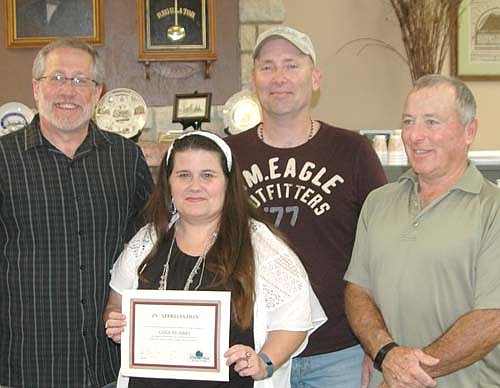 Stacy McConnell, owner of Catch My Thrift, second from left, and her husband Jerry, second from right, accept the EDA's Business Appreciation Award from Chris Stafford, president of the EDA, far left; and Mayor Jimmie John King, EDA member, far right.