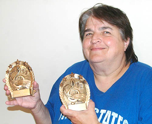 Gloria Nihart, a Stewartville singer-songwriter, displays the awards she recently earned from the American Christian Music Association.
