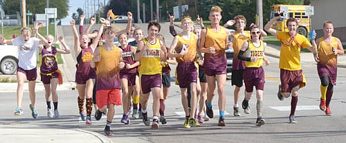 The Stewartville girls and boys cross country teams ran the game ball from the Tiger football team's homecoming opponent, La Crescent High School, delivering it to the Schaefer Field for the pep rally before the game on Sept. 30.