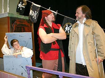 THE EAVESDROPPER -- Jim Hawkins (Alex Weston), left, overhears a secret agreement between Billy Bones (Tom Sheffrey, center) and Long John Silver (Jon Hyenga) during a dress rehearsal for Stewartville Community Theater's presentation of "Treasure Island," set to debut at the SHS PAC this Friday, March 7 at 7:30 p.m. 