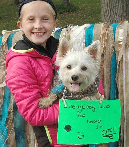 Danielle Mullenbach, 9, of High Forest, poses with her dog Dakota, a morkie, at the Stewartville Area Chamber of Commerce's third annual "Pets in the Park" at Florence Park on Saturday, Oct. 8.