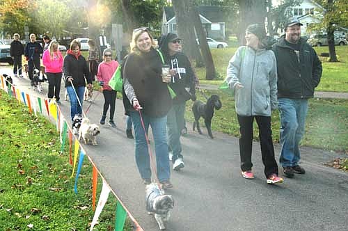 Paulette Teigen, front left, and other dog owners begin a one-mile walk at the third annual Pets in the Park event at Florence Park on Saturday morning, Oct. 8. Scores of local and area dog owners participated.
