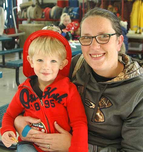 Kelly Albrecht of rural Stewartville holds her son Carson, 2 at the Stewartville Fire Department's annual open house on Wednesday, Oct. 12. The event is held each year to celebrate Fire Prevention Week.