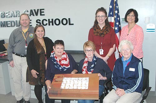 Members of the Stewartville American Legion Post 164 and Auxiliary Unit 164 celebrated American Education Week by delivering cupcakes to the staffs at a number of local schools last week, including the teachers and staff members at the recently completed Bear Cave Intermediate School. Seated from left, Peggy Paulson, Wanda Prescher and Delores Peterson of the Legion Auxiliary deliver cupcakes to Bear Cave educators, standing from left, Zane McInroy, Courtney Fakler, Anna Button and Lynn Bussan.