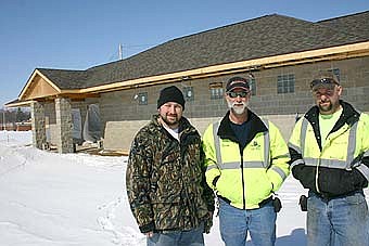 POOL'S PROGRESS -- The city's new pool is scheduled to be completed this June. Here, from left, Russ Lane of the Champion Group, Owen Sass of the city's public works department and Hale stand outside the new  pumphouse/bathhouse being built in conjunction with the construction of the new pool. The new building will also house locker rooms, showers and a concession area. 