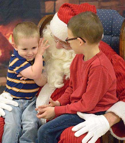 Jostin Cody, 2, is tickled by Santa's beard as his brother Jace, 6, listens in during the Stewartville Kiwanis Club's annual Pictures with Santa event at the Stewartville Civic Center on Saturday morning, Dec. 3. Many more photos of children visiting Santa will be available in the Stewartville STAR's annual Holiday Section, scheduled for distribution on Tuesday, Dec. 20.
