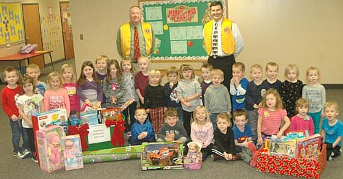 Bill Schimmel Jr., left, and Troy Knutson of the Stewartville Lions Club, standing in back, visited St. John's Wee Care at St. John's Lutheran Church on Thursday, Dec. 1 to collect gifts donated by Wee Care families to the annual Lions Club Christmas Anonymous gift and fund drive. Each year, the Lions deliver the gifts to a distribution center in Rochester, where the presents are made available to Olmsted County children who otherwise might not receive a Christmas gift.
