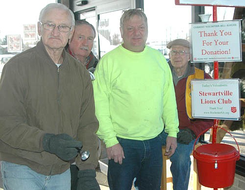 Thirty members of the Stewartville Lions Club signed up to ring bells for the Salvation Army at Fareway of Stewartville for a total of 96 hours between Nov. 18 and Dec. 23. The Salvation Army has set a goal to raise $1.2 million overall and $410,000 from its kettle collections for the needy in Olmsted County for the Christmas season, said Chuck Murphy of the Lions Club, second from left. Lions Club members have worked two-hour shifts at Fareway from 9 a.m. to 7 p.m. every day the store has been open since Nov. 18. Pat Kinyon of Rochester, second from right, was exiting Fareway on Friday, Dec. 9 when he met Lions Club members, from left, Darrel Jaeger, Murphy and Ed Doty.
