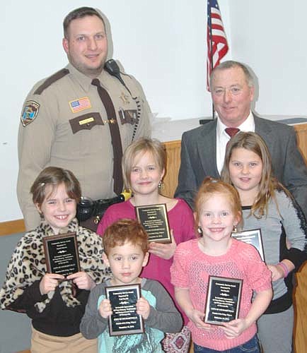 Five local children each received the Mayor's Award for Community Service at the city of Stewartville's annual recognition and awards ceremony at the Stewartville Civic Center on Wednesday, Dec. 14. Recipients included, front row, from left, Cael Szydel and Ava Szydel. Second row, from left, Zurich Hanson, Alivia Szydel and Ashlyn Olson. Back row, from left, Mike Strelow, Stewartville's community oriented policing (COPS) deputy, and Mayor Jimmie-John King, who presented the awards. The children were recognized for turning in a large bag of quarters they found along a city trail on Oct. 22.