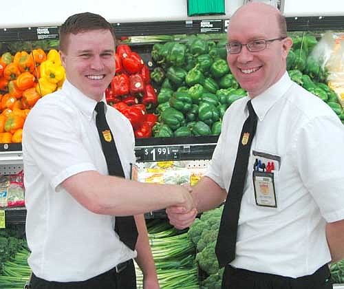 Mike Hochstein, the new assistant grocery manager of Fareway in Stewartville, left, shake hands with Robert Hruska, the store's grocery manager.