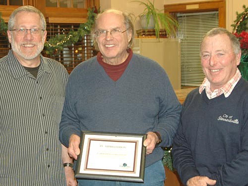 Charlie Brown, owner of PC Applications Consultants, Inc. of Stewartville, center, accepts  the EDA Business Appreciation Award from Chris Stafford, EDA president, left; and Mayor Jimmie-John King, a member of the EDA.