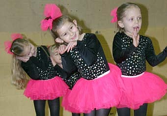 Just For Kix dancers MiKenna Hettinger,  Kendall Clausen and Cesca Kassel dance the Bunny Hop at the Stewartville Chamber Home Show. 