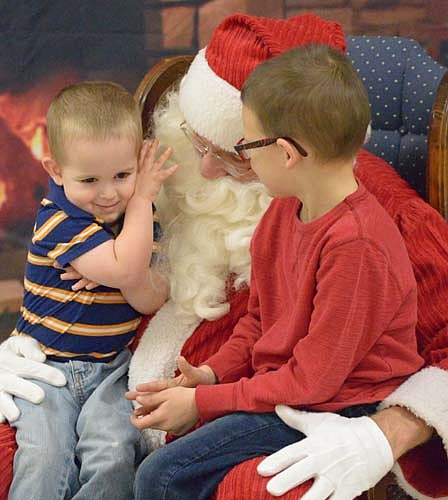 Justin Cody, 2, is tickled by Santa's beard as his brother Jace, 6, listens in during the Stewrtville Kiwanis Club's annual Pictures with Santa event at the Stewartville Civic Center on Saturday morning, Dec. 3. Hundreds of children visited Santa Claus that day from 9 a.m. until noon.
