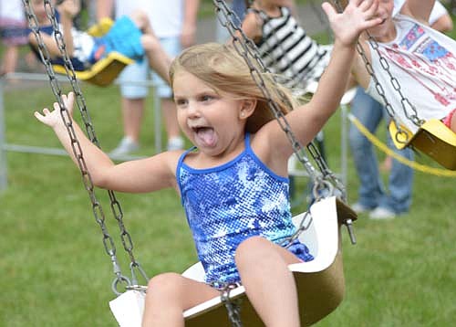Oakley Reichel, 3, seems to be proclaiming, "Look Mom, no hands!" as she enjoys the swing ride at the Stewartville Area Chamber of Commerce's Independence Day Summerfest celebration on Monday afternoon, July 4.