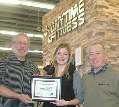 Samantha Riess, general manager of Anytime Fitness, center, accepts the EDA's Business Appreciation Award from Chris Stafford, president of the EDA, left, and Mayor Jimmie-John King, also a member of the EDA.