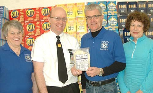 Robert Hruska, grocery manager at Fareway, second from left, invites Fareway shoppers to donate to the Stewartville Kiwanis Club's 14th annual Food for Kidz food-packaging event for the poor at Fareway through the end of February.  Kiwanis Club members include, from left, Mary Brouillard, Todd Weston and Carol Youdas.