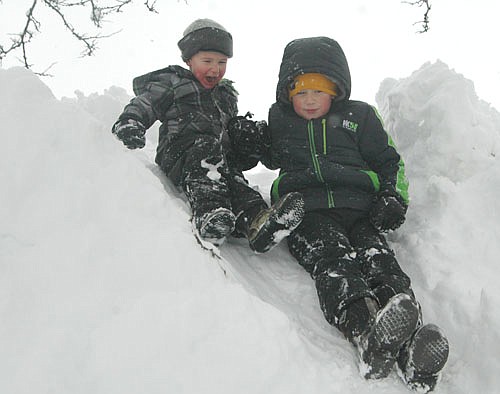 Carsen Nagel, 3, left, and his brother Caden, 7, of Stewartville, enjoyed plenty of fun in the snow after a winter storm dumped about 11 inches of snow on the city on Tuesday, Jan. 24 and Wednesday, Jan. 25. Many times over, the boys climbed to the top of a huge snow pile and slid back down again.