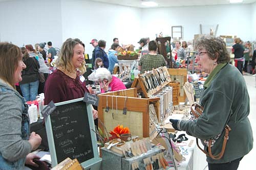 Cynthia Kiehne of Racine, right, browsed among the 34 booths at the Stewartville Area Historical Society's annual Cabin Fever Flea Market at the Stewartville Civic Center on Saturday, Feb. 18. Amanda Corey, owner of Altered by Grace of Austin, in the foreground at left, and Annette Ekoue, owner of Rustic Design of Austin, welcomed Kiehne and other shoppers to their booths.