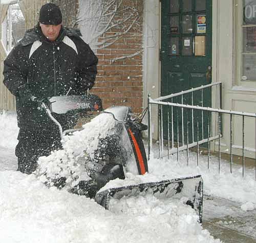 A winter storm dumped about 10 inches of snow on Stewartville and the area on Thursday evening, Feb. 23 and Friday morning, Feb. 24. Above, Seth Stier uses a snow blower to clear the sidewalk in front of Sammy's Family Restaurant.