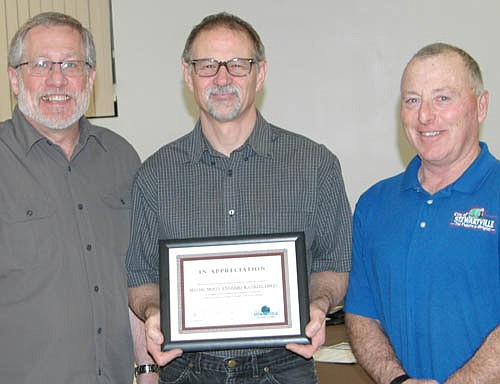 Al Chihak, owner of Mystic Moon Antiques & Collectibles, center, accepts the EDA's Business Appreciation Award from Chris Stafford, president of the EDA,left, and Mayor Jimmie-John King, a member of the EDA.