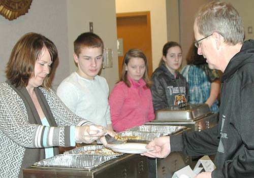 The Stewartville American Legion Auxiliary Unit 164 hosted an egg bake breakfast at the Legion Hall on Sunday morning, March 5. Proceeds will help pay for Stewartville Middle School eighth graders' upcoming trip to Washington D.C. Above, Kara Zelinske, far left, serves Brent Richardson of Stewartville. Other workers include, from left, Keegan Zelinske, Bailee Swanson and Katelyn McClellan.
