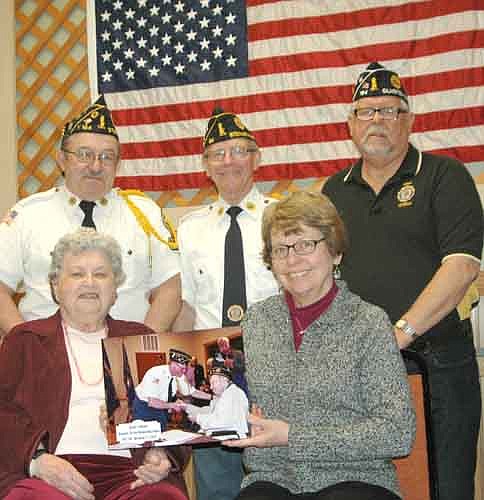 On Nov. 11, 2016, Duane J. Helland accepted an award for 70 years of continuous membership in the Stewartville American Legion Post 164. Helland, a World War II&#8200;veteran, served as a paratrooper in the U.S. Army in Okinawa. He received his 70-year Legion pin about 2 1/2 months before he died on Feb. 1 at the age of 92. Above, front row, from left, Mary Helland, Duane's widow, and Kathy Jensen, his daughter, display the photo of Duane Helland accepting his 70-year pin last Veterans Day. Last week, the women donated the photo to the Legion. Legion leaders who accepted the photo include, standing from left, Roger Peterson, commander; Roger Barsness, adjutant; and Richard Paulson, vice commander.