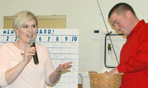 AND THE WINNER IS...-- Rachel Wick, an anchor and reporter for KAAL-TV, left, the master of ceremonies for the second annual Toast &&#8200;Taste, waits for Justin Lonien to pick the name of a raffle winner at the Rochester Event Center on Friday evening, March 24.