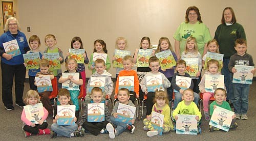 Janice Hagen, president of the Stewartville Kiwanis Club, standing at far left, brought new books to the children at St. John's Wee Care in Stewartville last week. Standing at right in back, from left, are Lori Torgerson and Barb Howes of Wee Care, both of whom are members of the Stewartville Kiwanis Club.