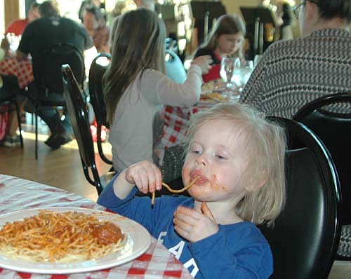 Gracelynn Drees, 2, of Stewartville, enjoyed her spaghetti one noodle at a time at the St. Bernard's Catholic Church Men's Club's biennial Mama Tranchita Spaghetti Dinner at Riverview Greens Country Club on Tuesday, March 28. The Men's Club served 575 dinners that evening.