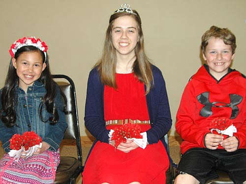 Johanna Welter, poppy queen, center; is flanked by Madelyn En, poppy princess, left; and Cole Kropp, poppy prince. The three will ride in the Memorial Day and Fourth of July Summerfest parades. Madelyn and Cole, third graders at Bear Cave Intermediate School, earned their titles by virtue of the quality of their short essays and poppy artwork.