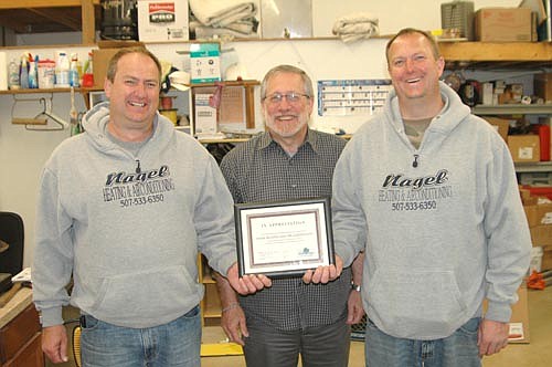 Craig Nagel, left, and Ryan Nagel, right, of Nagel Heating & Air Conditioning, accept the Economic Development Authority's Business Appreciation Award from Chris Stafford, president of the EDA.