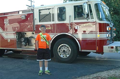 Graysen Schneider, a fourth grader at Bear Cave Intermediate School, rode to school in a Stewartville Fire Department truck on Monday morning, June 5. Graysen earned the ride by raising $435, the most of any student at Bear Cave School, for the school's Jump Rope for Heart event. Proceeds from Jump Rope for Heart go to the American Heart Association.