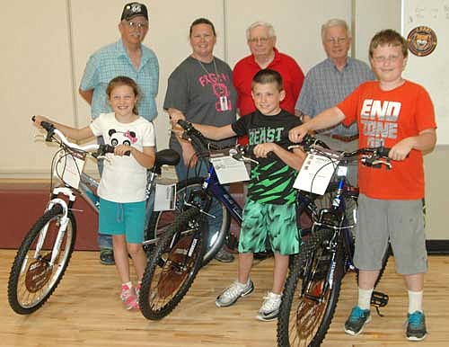 Three Bear Cave Intermediate School students have each won a bicycle courtesy of the Books for Bikes program sponsored by the Stewartville Masonic Lodge and the Olmsted County Deputy Sheriffs Association. Students include, front row, from left, Abbie Langseth, third grader; Dylan Scanlon, fourth grader; and Ty Peterson, fifth grader. Standing in back, from left, are Doug Brick of the Stewartville Masonic Lodge; Jennifer Martin, library paraprofessional at Bear Cave School; and George Thompson and Len Griffith of the Masonic Lodge. Students become eligible for the bicycles by reading books, submitting book reports and making book covers. The winning students' names are announced at an all-school assembly at the end of the first and second semesters of each school year.